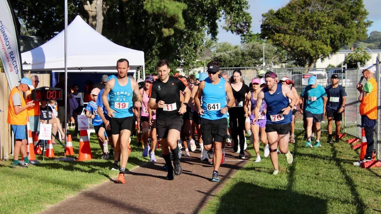 Runners crossing the starting line at Sri Chinmoy Auckland Series 2025 event in War Memorial Park, capturing the joy of completion.